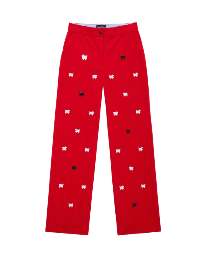 A pair of red corduroy trousers with a pattern of sheep and other small animals